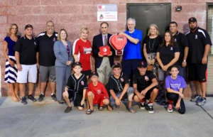 Medicor Cardiology donates an AED to Bridgewater Baseball team with players and coaches