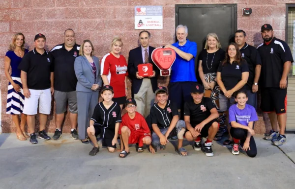 Medicor Cardiology donates an AED to Bridgewater Baseball team with players and coaches