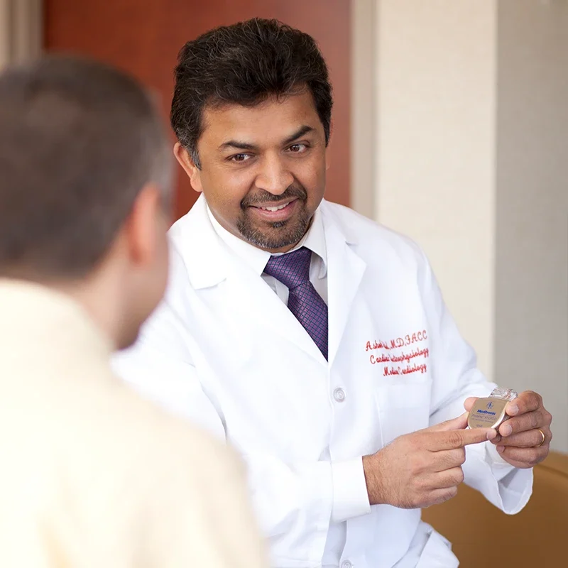 Cardiologist explaining implantable device for arrhythmia treatment to patient in New Jersey