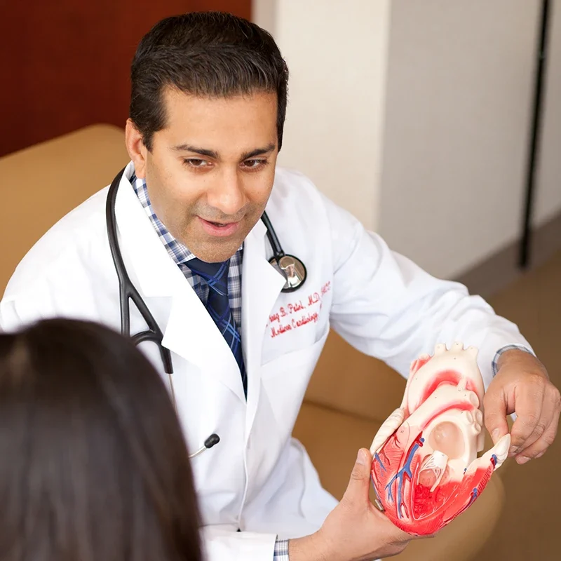 Cardiologist explaining heart condition and catheterization procedure to patient in New Jersey